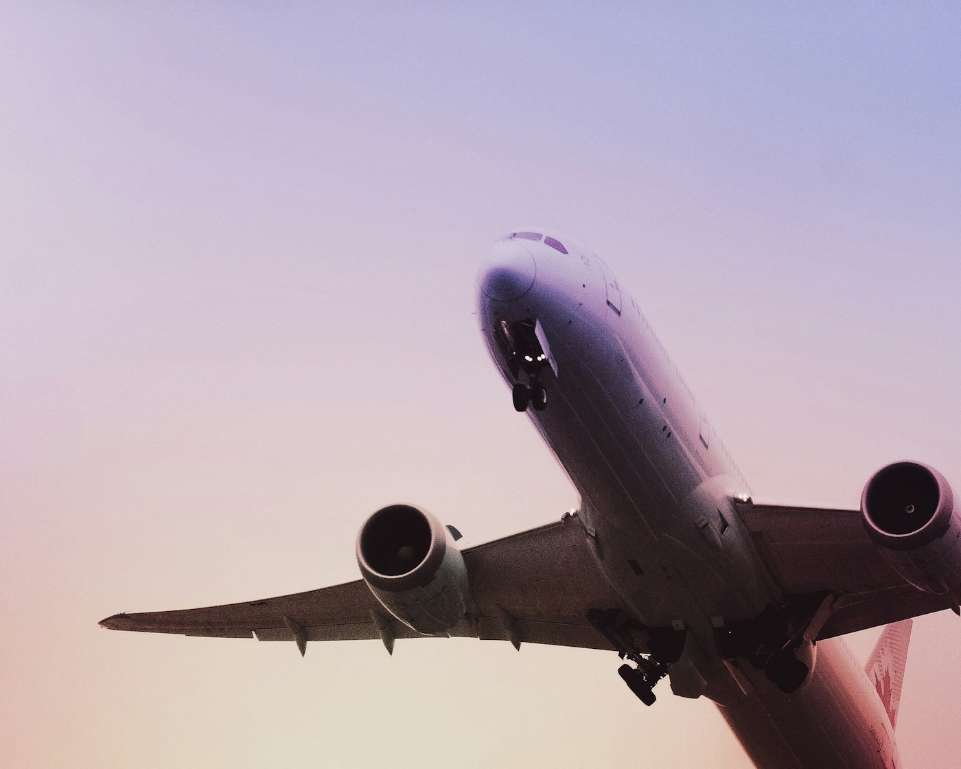 Passenger jet taking off at dusk