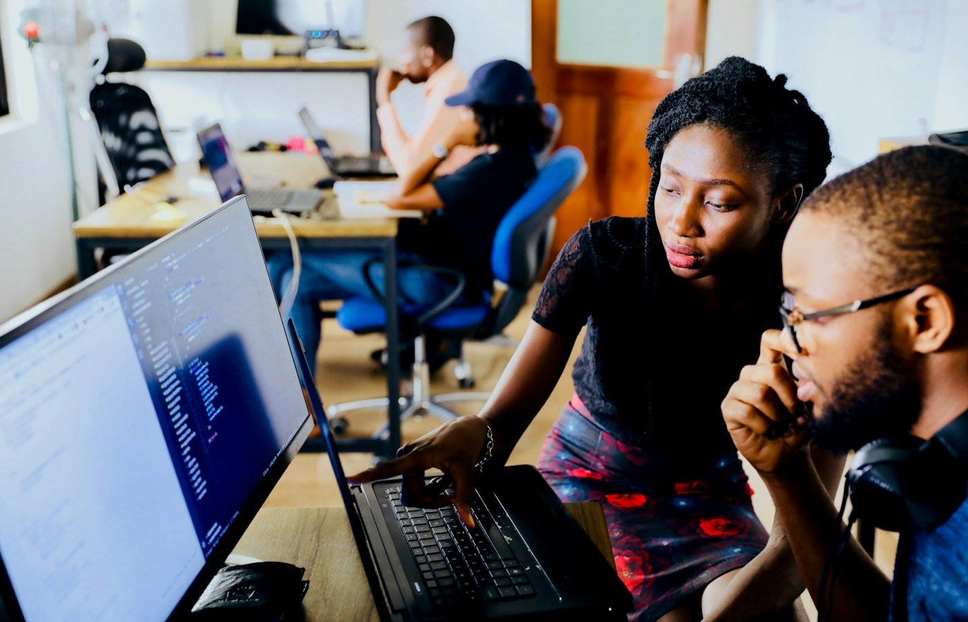 Students collaborating around a laptop